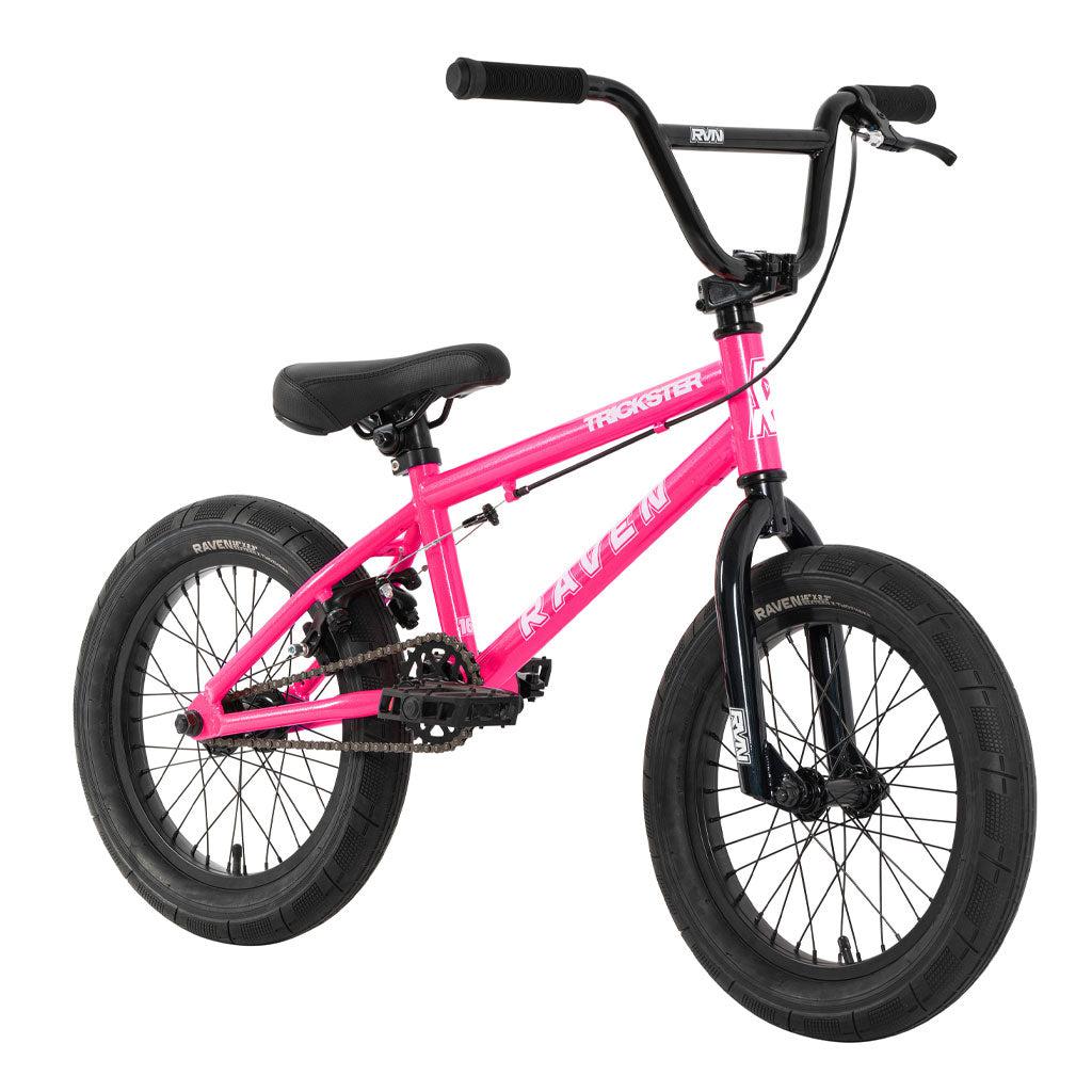 The Raven Trickster 16 Inch Bike is a pink BMX featuring a black seat, black handlebars, and black tires. "Raven" is prominently displayed on the frame with "Trackstar" on the top tube. This sleek ride includes three-piece cranks for enhanced performance and durability.