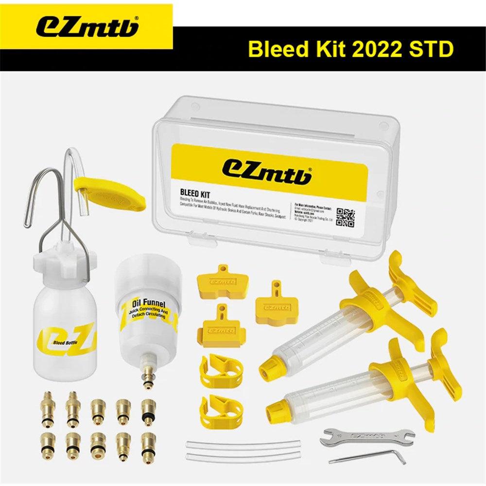 An EZ MTB Universal Bleed Kit - Standard Kit, including syringe, oil funnel, fluid container, various adapters, wrenches, and small yellow caps, displayed on a white background.