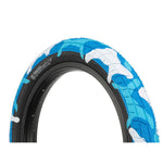 Close-up of an affordable Salt Tracer 12 Inch Tyre with a blue and white camouflage tread pattern and black sidewall, angled against a plain white background, highlighting its improved traction.