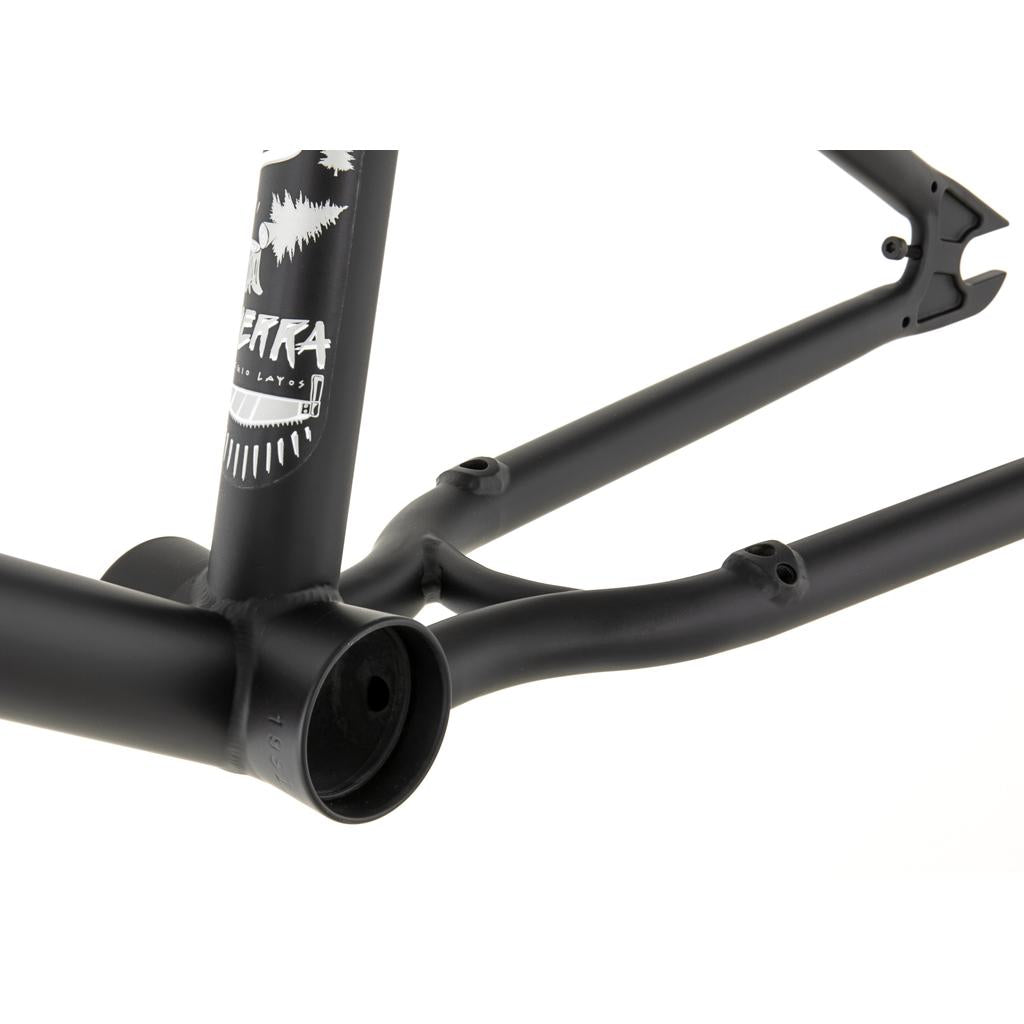 Close-up of the Fly Bikes Sierra Frame with forest-themed graphics, featuring a 4130 CrMo black bicycle frame and visible joints.