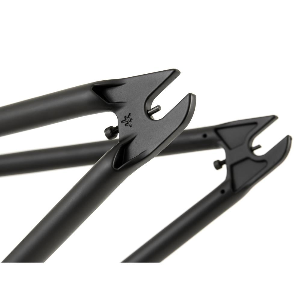 Close-up of three black Investment Cast bicycle fork dropouts with a sleek, matte finish set against a white background, designed to perfectly complement the rugged durability of the Fly Bikes Sierra Frame made of 4130 CrMo.