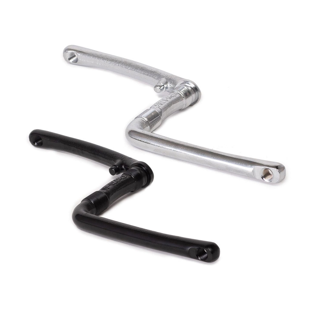 The Salt One Piece Crank features two bicycle crank arms, one in silver and one in black, each with a distinctive Z-shaped design, set against a white background. Ideal for restoration projects or complementing RSD drivetrains.