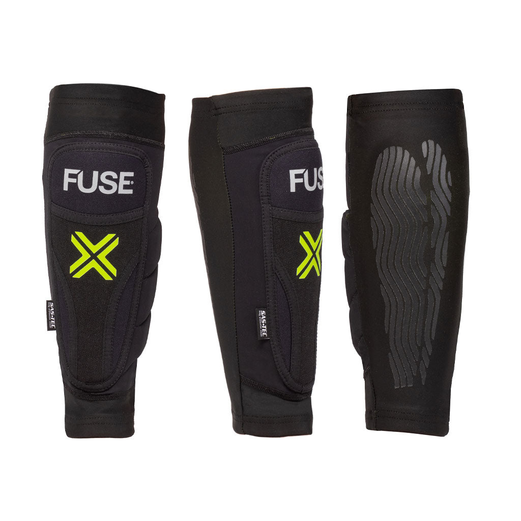 Three black shin guards with neon yellow X logos and textured patterns on the back, labeled "Fuse Omega Shin Whip Pads." The middle shin guard features breathable Lycra side padding and a label indicating "Fuse Protection.