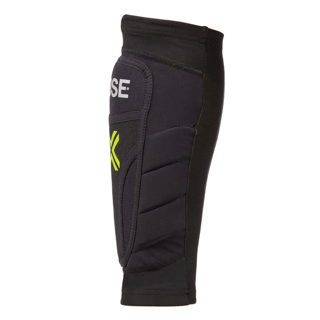 Side view of a black Fuse Omega Shin Whip Pads with padded sections, breathable Lycra, and neon green accents on a white background.