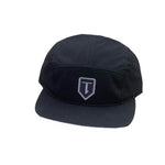 This sleek black cap, made from cotton twill, displays a "T" emblem on the front. Its five-panel construction and embroidered logo make it an ideal choice for any fan of the Terrible One Patch Camp Cap.