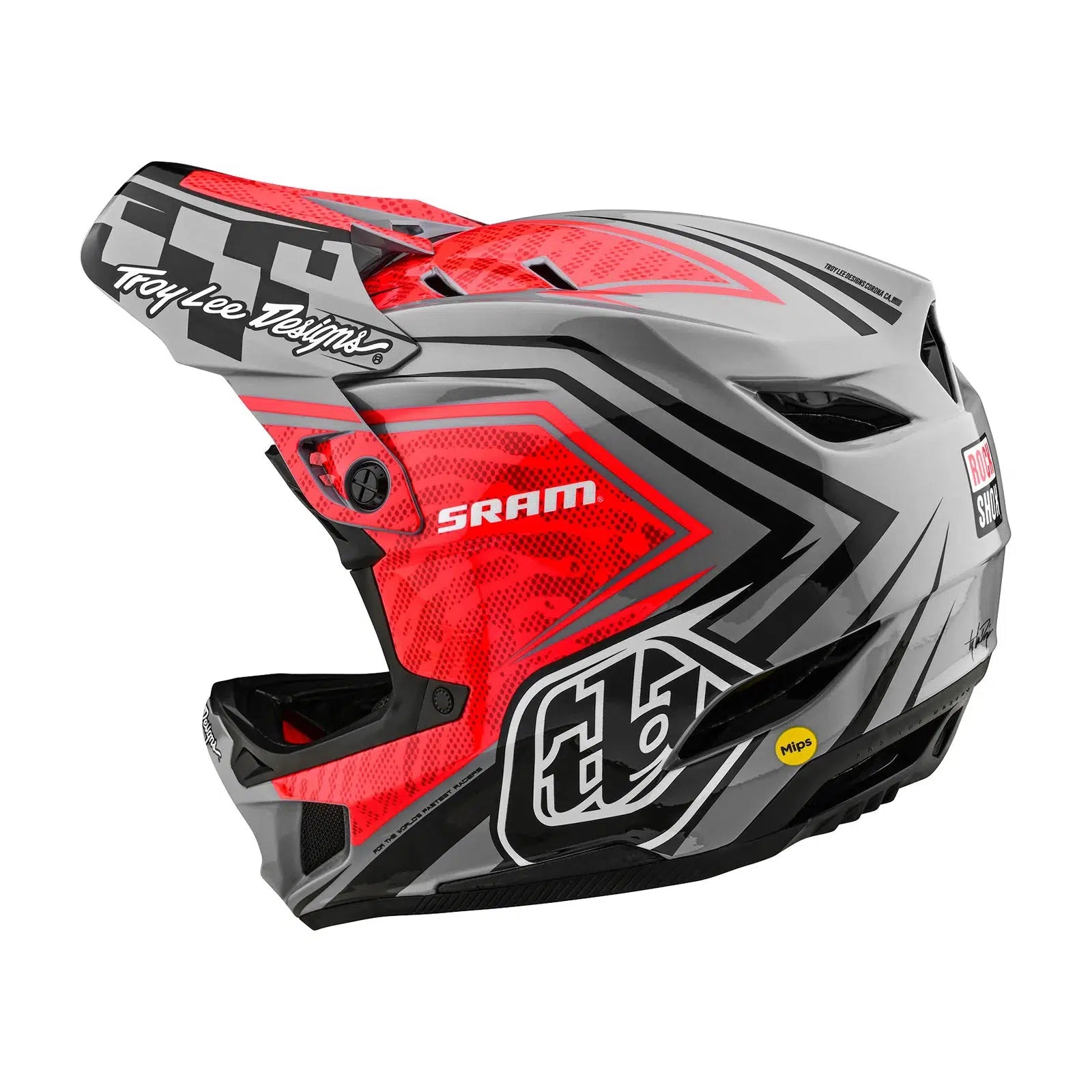 A TLD D4 Carbon AS Helmet W/MIPS SRAM Red / Black with a checkered design on it.