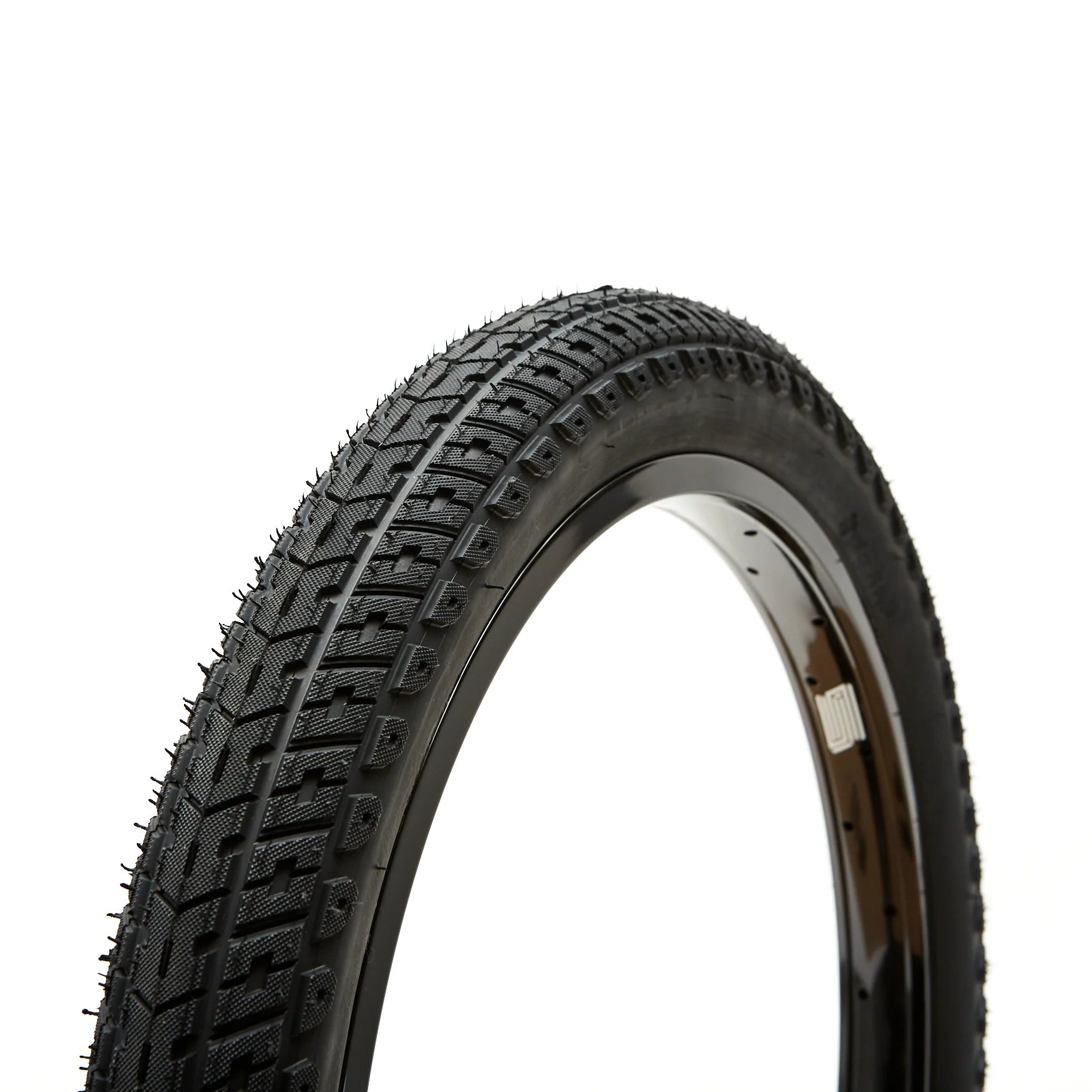 Close-up view of the United Indirect Tyre, a result of the Bicycle Union collaboration, showcasing its aggressive directional dirt profile and side wall. The background is plain white.