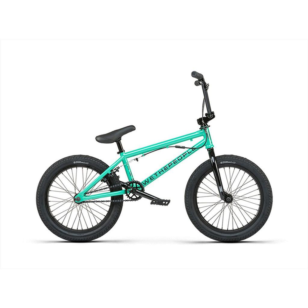 The Wethepeople CRS FS 18 Inch BMX bike in teal boasts sleek black tires and a matching black seat, set against a plain white background.