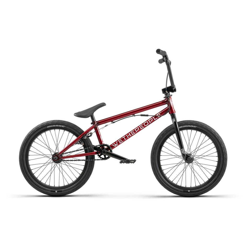 The Wethepeople Versus 20 Inch BMX Bike features a vibrant red Chromoly frame with the brand logo. It includes knobby tires, a single gear, and a raised handlebar for an exciting ride.