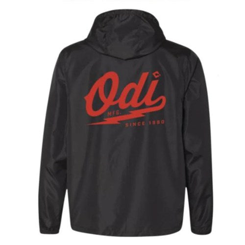 The ODI Heater Windbreaker is a lightweight black jacket with a hood, featuring large red "Odi Mfg. Since 1980" text on the back.