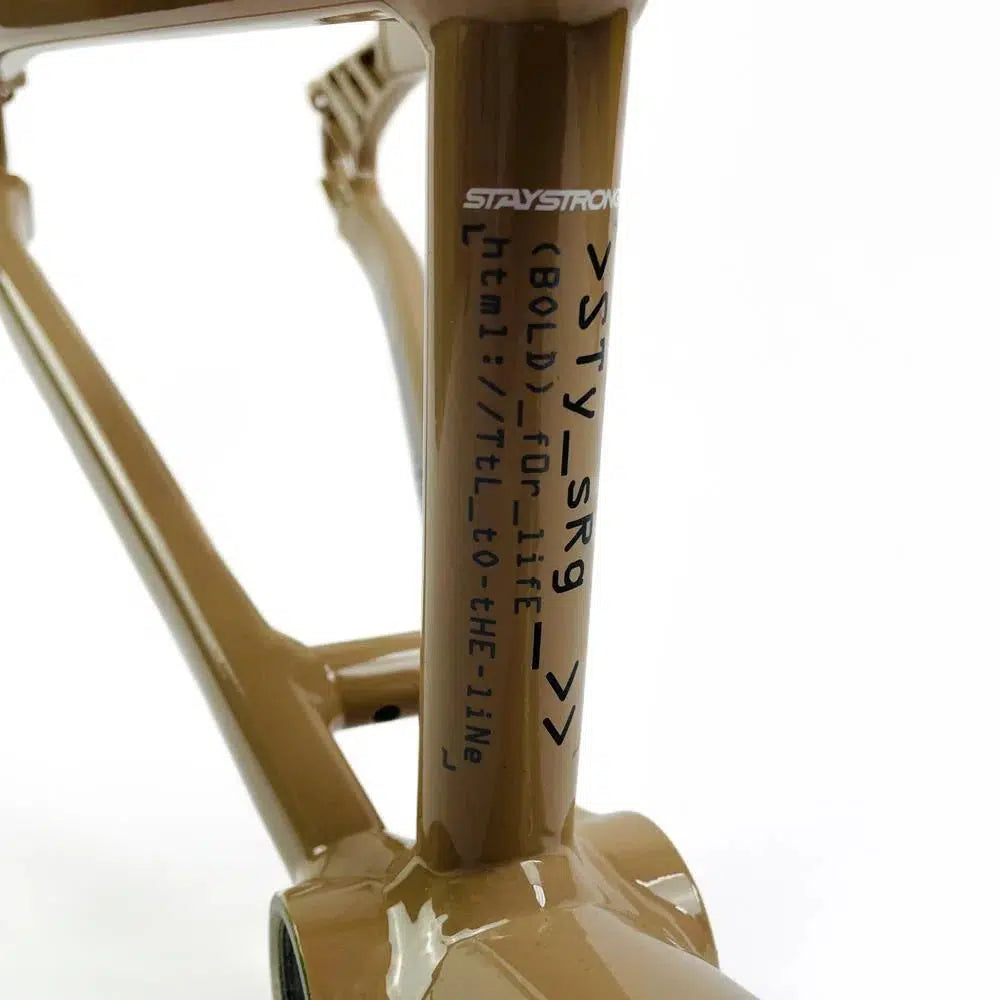 Close-up of a Staystrong V5 Disc Junior Frame with text and symbols printed on its side. The frame, crafted from 6061 alloy tubing, is painted a stunning metallic brown.