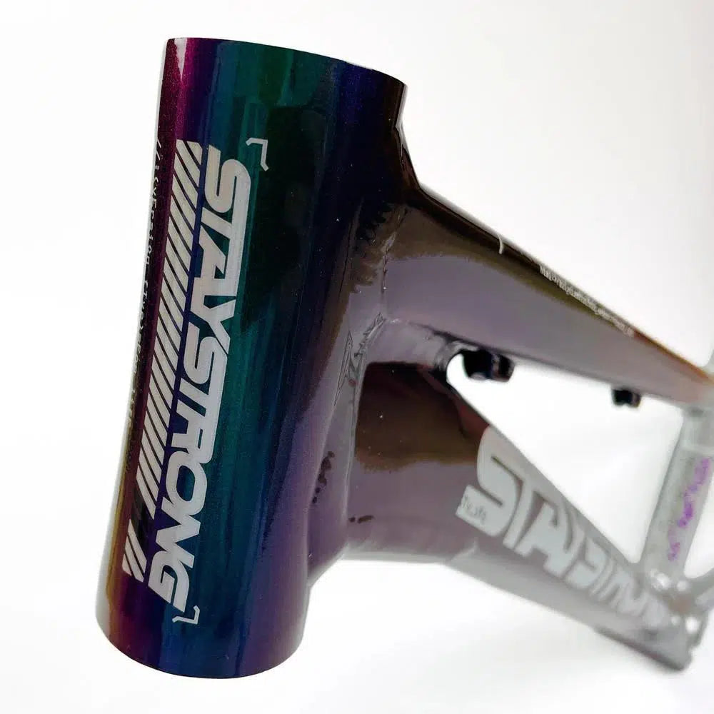 Close-up of a Staystrong V5 Disc Mini Frame bicycle with a colorful gradient finish and "STAYSTRONG" logo displayed prominently, featuring an aluminium race frame design and equipped with disc brakes.