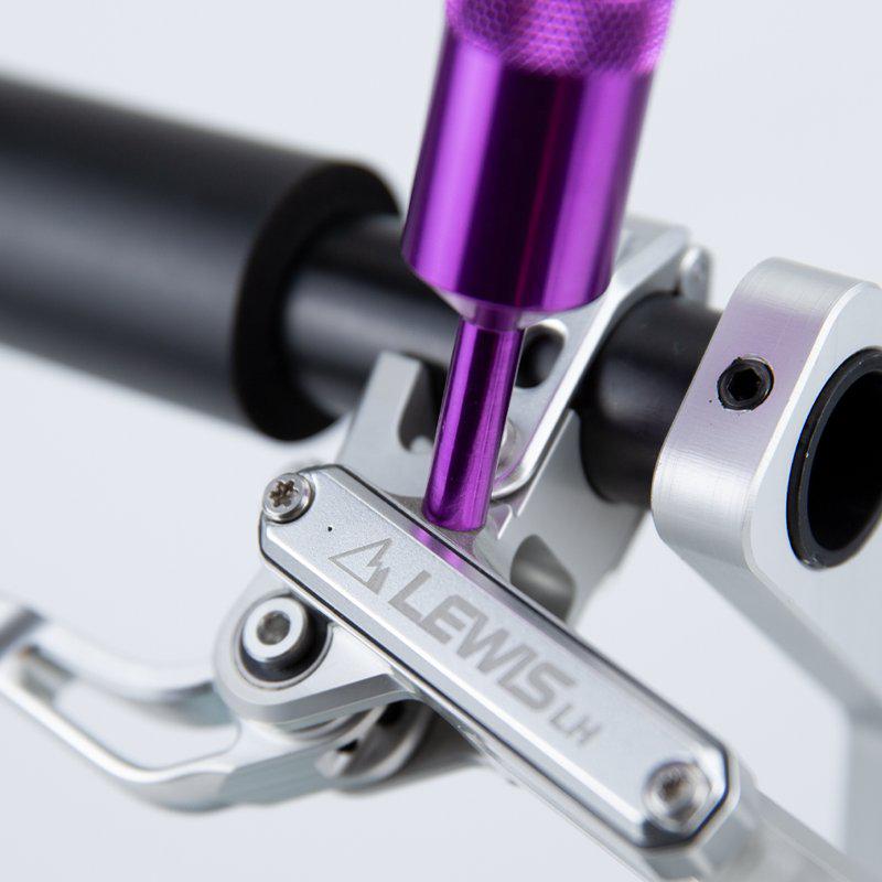 Close-up of a purple tool aligning with a screw on a silver Lewis Portable Oil Funnel handlebar clamp.