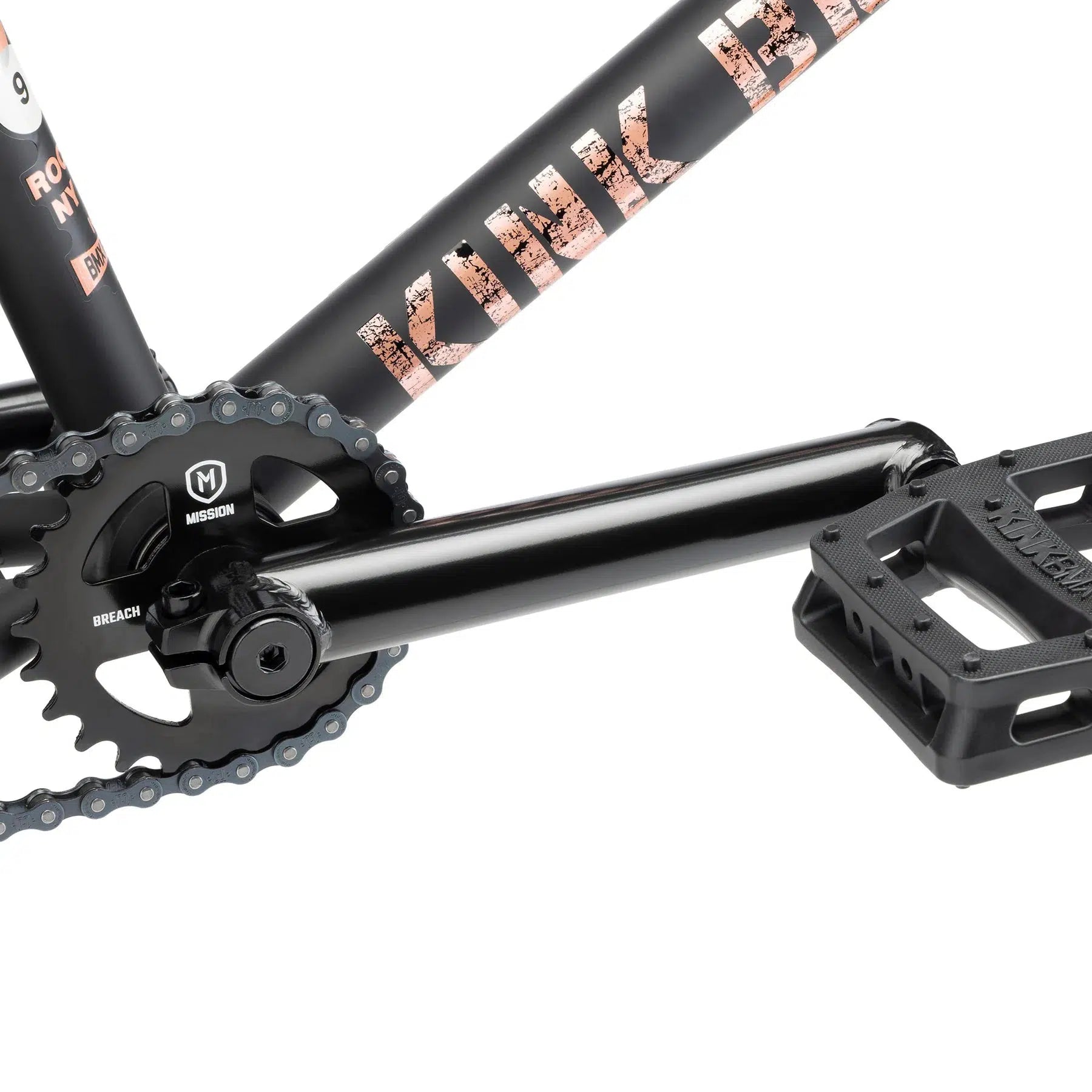 Close-up of the Kink Gap XL 20 Inch Bike's black chainring, crank, and pedal with branding on the frame and components, highlighted by its modern geometry that enhances performance.