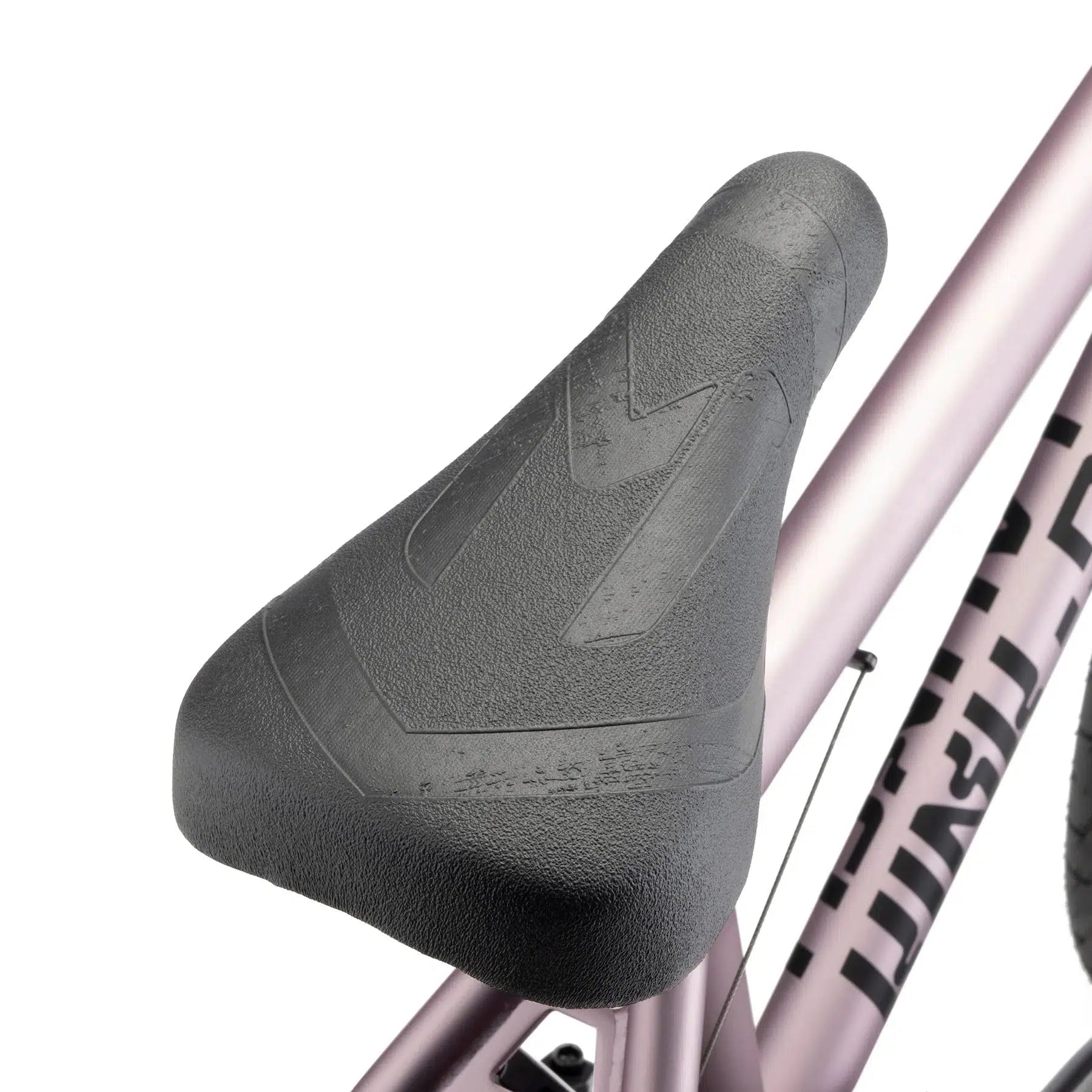 Close-up of a black saddle mounted on a metallic pink Kink Launch 20 Inch Bike frame, with partially visible branding.