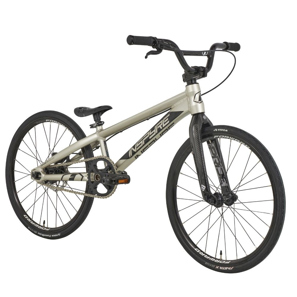 The Inspyre Evo-C Disc Junior Bike 2025 is a silver BMX bike with black handlebars and wheels, featuring "Inspire" branding on the frame—ideal for BMX racing enthusiasts.