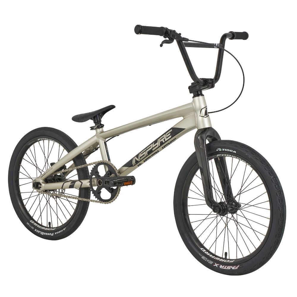 The Inspyre Evo-C Disc Pro L Bike 2025, designed with race geometry, features a silver frame with black handlebar, seat, and tires. Adorned with the "Inspyre" brand name, it offers an unparalleled BMX racing experience.