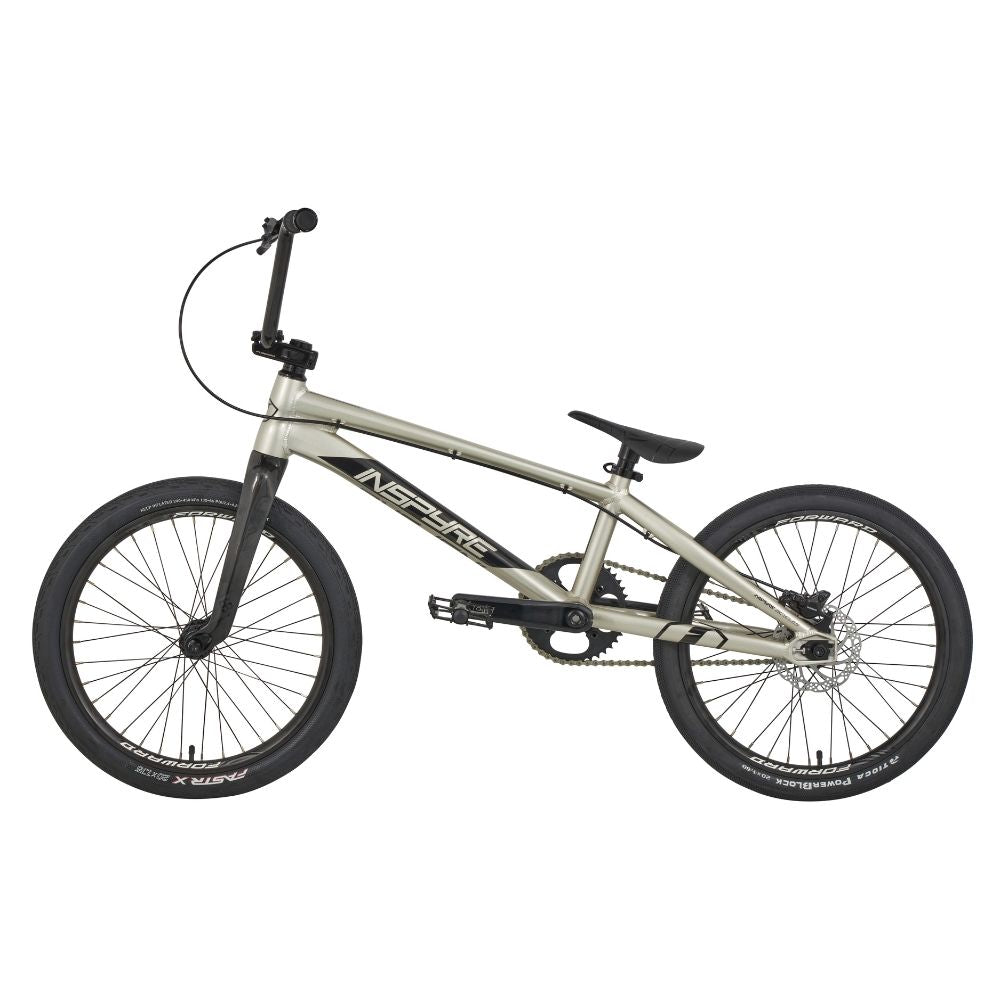 A silver Inspyre Evo-C Disc Pro XL Bike 2025 with black handlebars, seat, and wheels, featuring "Inspire" on the frame and race-winning geometry perfect for BMX racing.