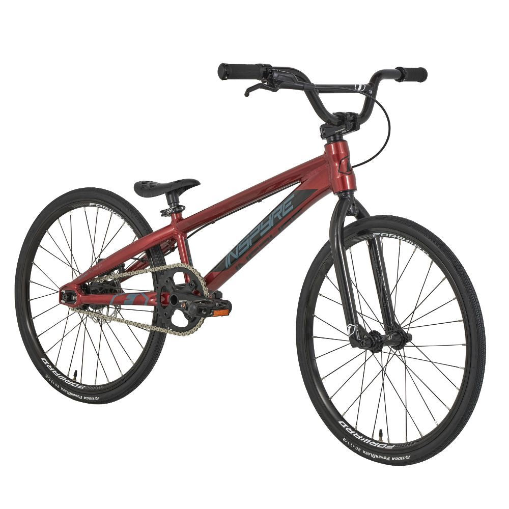 The Inspyre Evo Disc Junior Bike 2025 is a red and black BMX bike with race geometry, featuring thin tires, a lightweight frame, and a single gear.