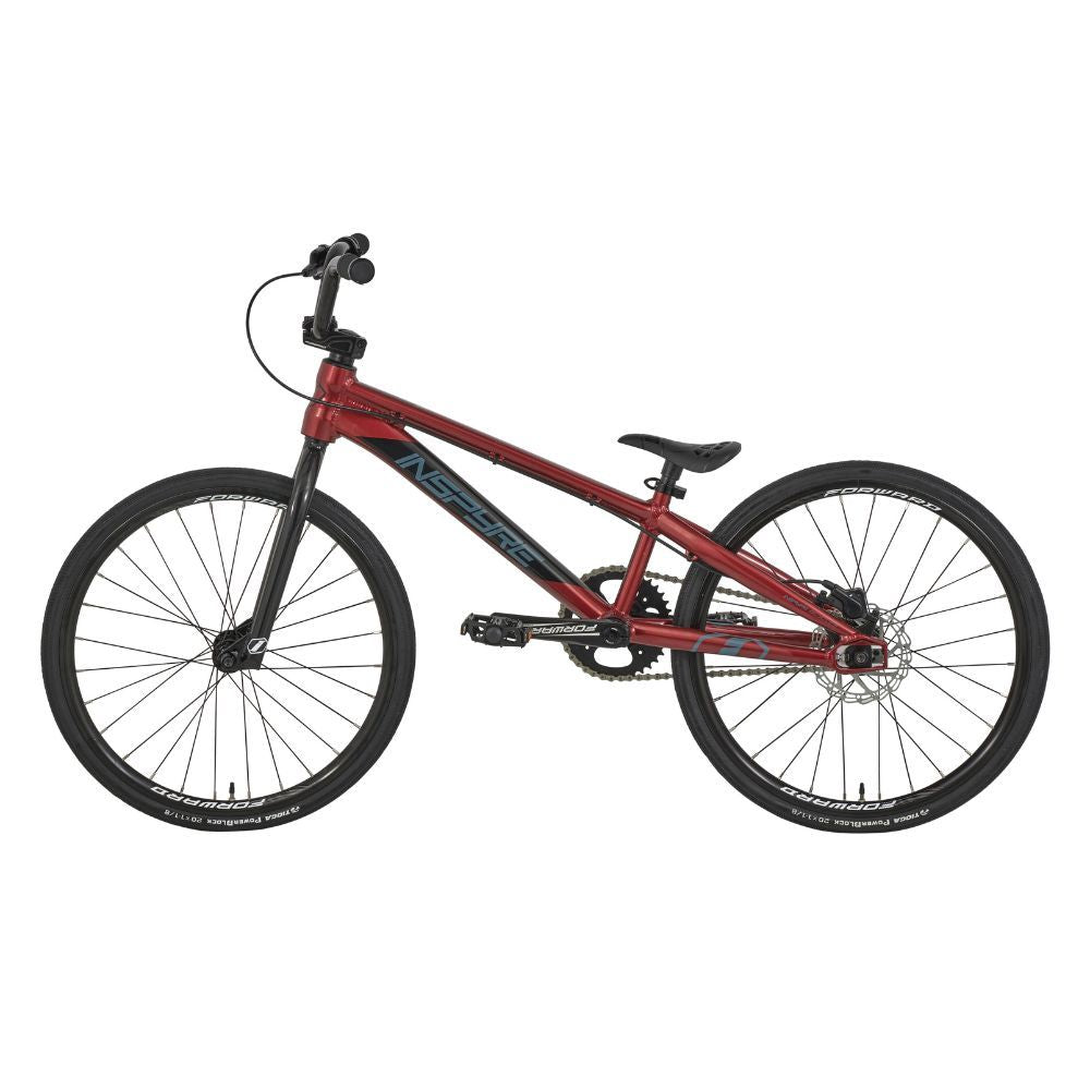 The Inspyre Evo Disc Junior Bike 2025 is a red BMX bicycle with race geometry, featuring black tires and a blue logo on the frame, displayed in profile against a plain white background.