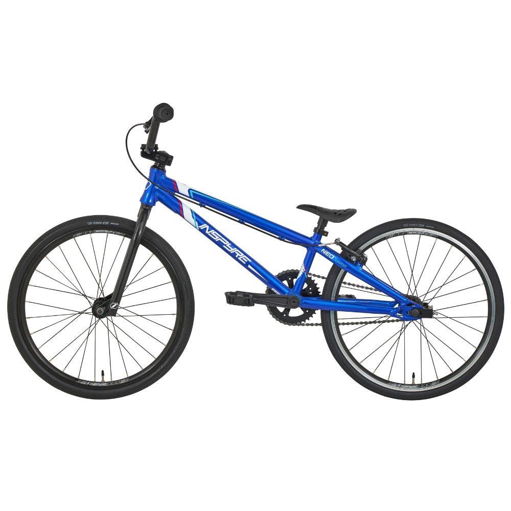 The Inspyre Neo Junior Bike is a blue BMX race bike featuring an entry-level, lightweight aluminum frame, complemented by black tires and a sleek side-view design.