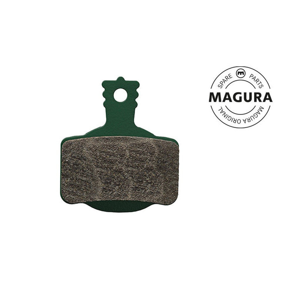 Image of the Magura 7 Series MT Disc Brake Pad, likely featuring a high-performance compound, with a green backing and brown friction surface. The Magura logo is displayed on the right side.