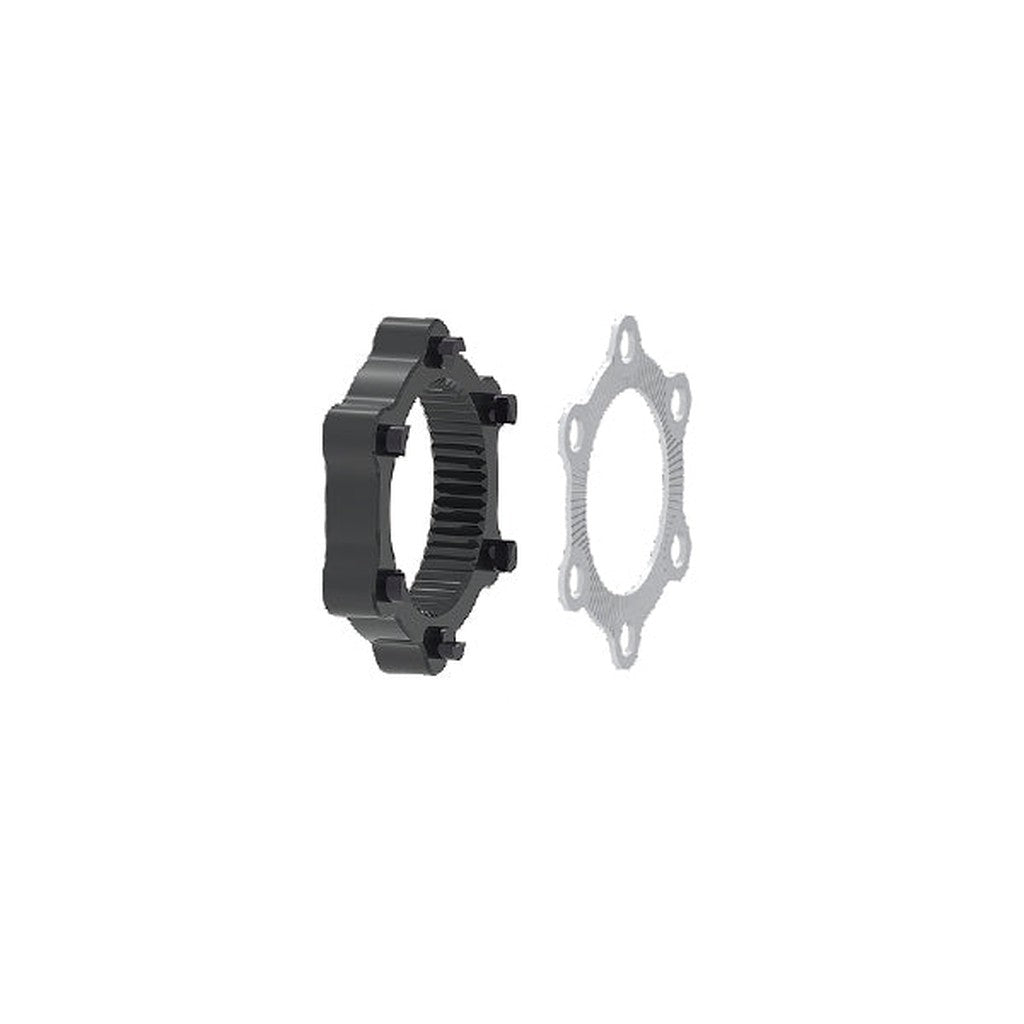 The Bengal Centerlock ISO Adapter Kit comprises two mechanical components: a cylindrical cogged piece on the left resembling a Centerlock style hub, and a flat, ring-shaped gasket with four symmetrical holes on the right.