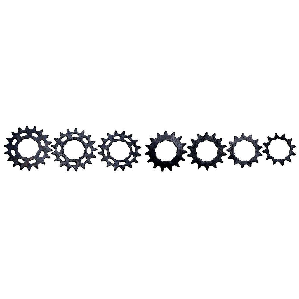 Six variously sized and shaped Excess Steel Cog 3/32 Shimano Fitment cassette hubs aligned in a row on a white background.