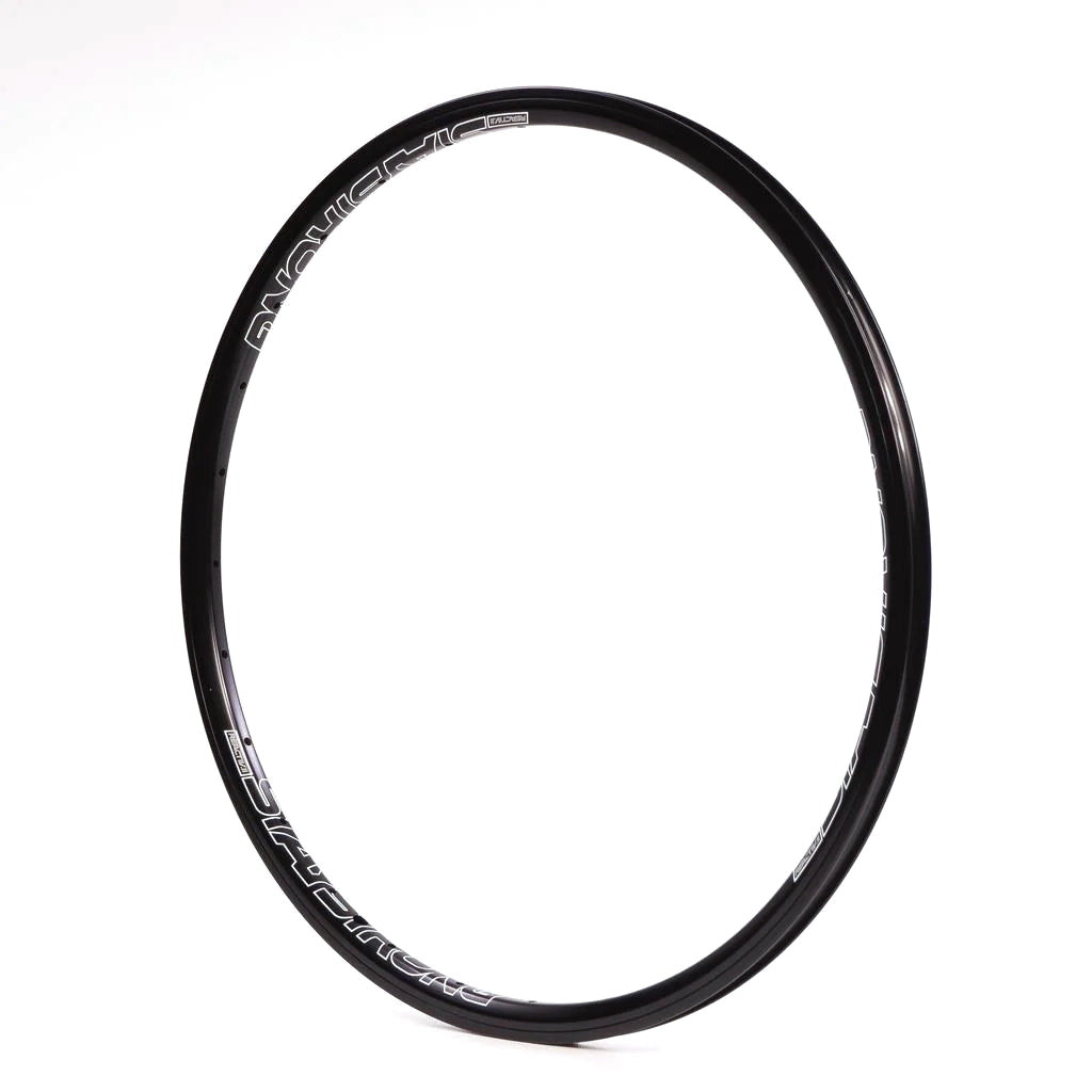 A black Stay Strong Reactiv-2 Rim 28 Hole, featuring white branding text, is crafted for young racers who prioritize lightweight wheels and is showcased against a plain white background.