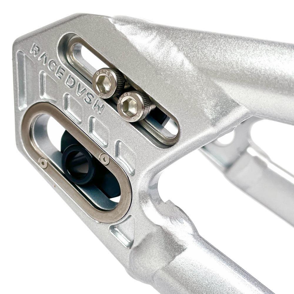 Close-up of a metallic bike frame with "RACEDVSM" engraved on it, showcasing the precision bolts and an integrated mounting bracket. This Staystrong V5 Disc Pro L Frame, crafted from 6061 alloy tubing, is designed to accommodate a disc brake system.