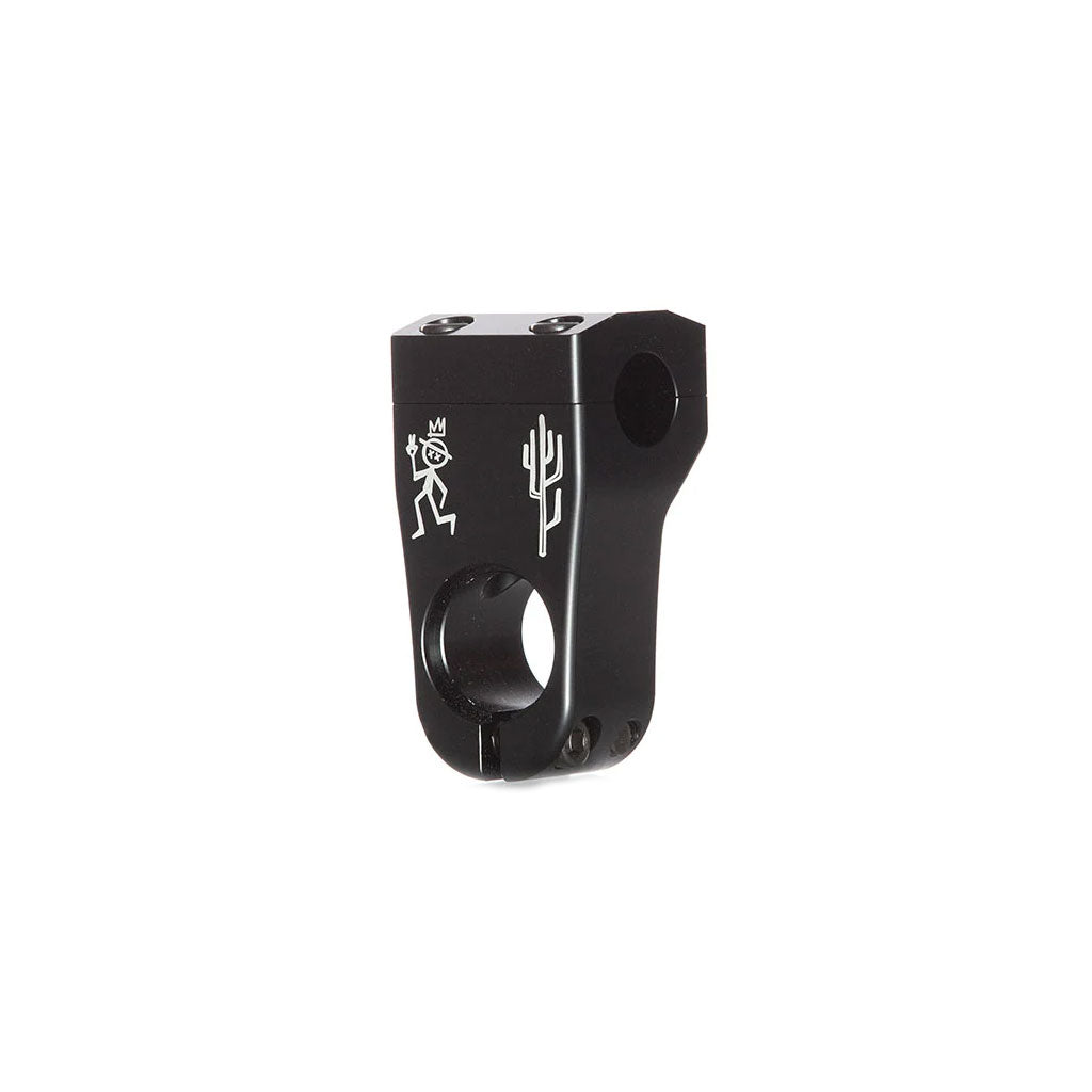 The Demolition Kevin Peraza Front Load Stem is a black metal BMX bike stem featuring intricate engravings of a skeleton and a cactus. Designed with a rounded front and an attachment hole, this Kevin Peraza Signature piece combines aesthetic detail with functionality.