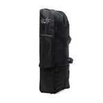 The black travel snowboard bag, similar in design to the DK Golf Flight Bike Bag, stands upright with side pockets and buckle straps for secure closure.