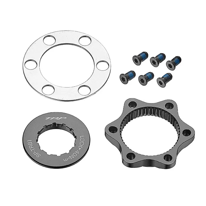 Picture of the TRP Centerlock ISO Adapter Kit - Internal Tool type, showing its various components: a metal rotor lockring, a spacer ring with multiple holes, a star-shaped spline adapter, and six screws.