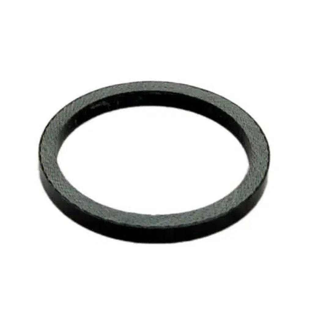 A Carbon Headset Spacer / 1-1/8th in sleek black sits on a pristine white background, resembling a refined rubber O-ring.