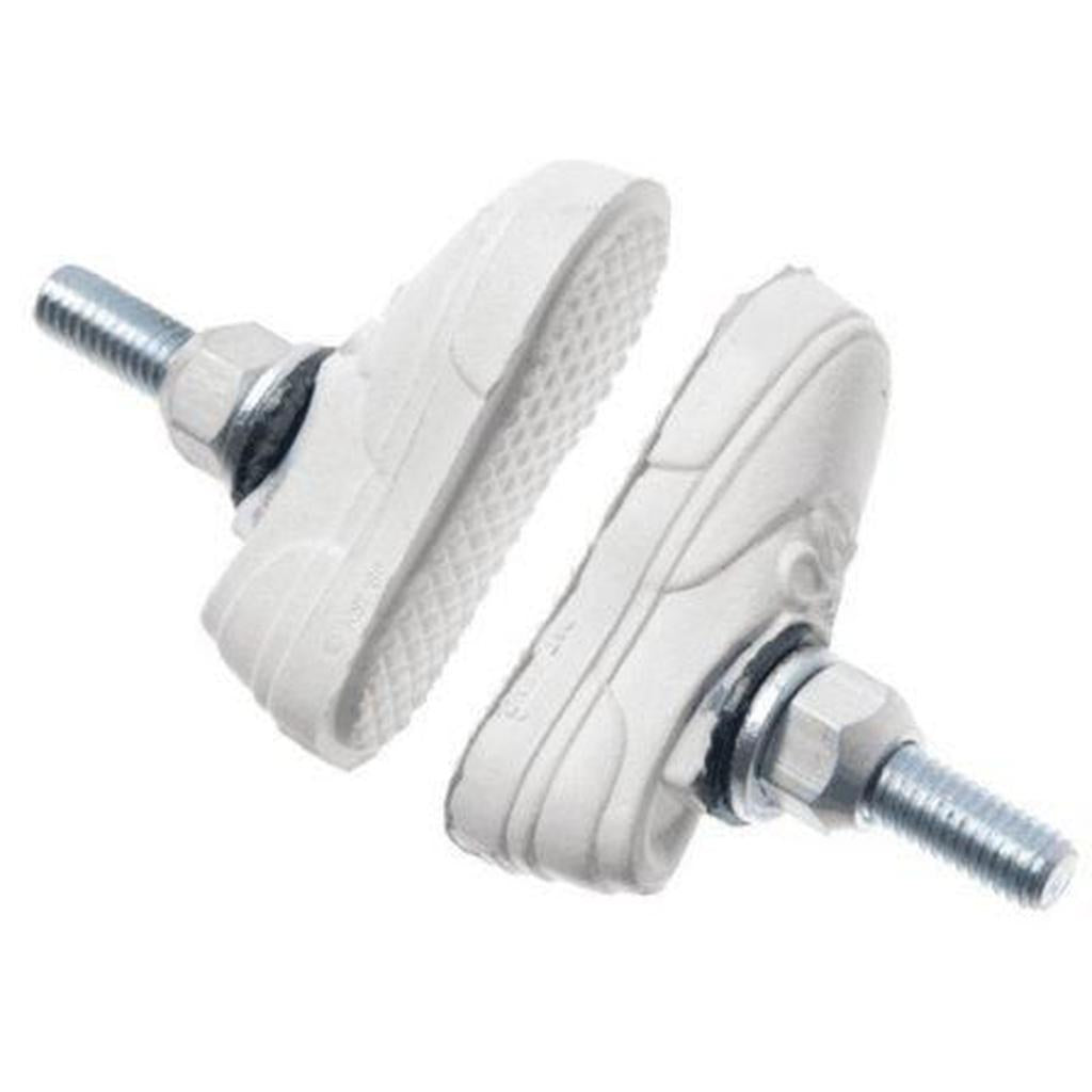 Two Kool Stop X Vans Brake Pads, white with threaded bolts at the heels like brake shoes, face each other against a white background.