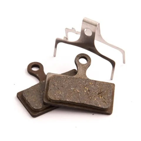 The Clarks VX Organic Disc Brake features two rectangular brake pads with metal backing plates, a metal spring clip, and enhanced braking power for superior stopping performance.