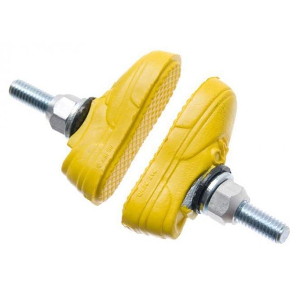 A close-up shows two Kool Stop X Vans yellow brake pads with bolts and washers, featuring rim-friendly compounds, against a white background.