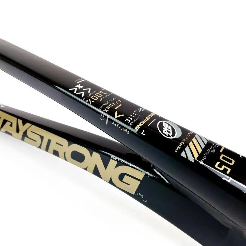 Close-up image of black handlebar frames with gold and white text, including "STAYSTRONG" and technical specifications for the Staystrong V5 Disc Pro XL Frame.