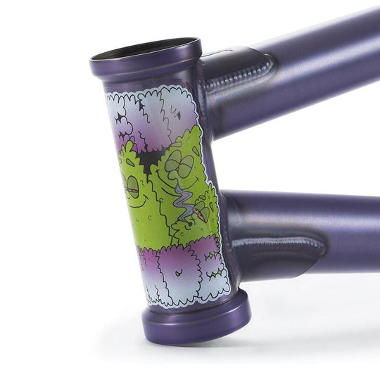 The Fiend Morrow V4 Frame features street-oriented geometry, a durable 4130 chromoly build, and a stylish purple finish with cartoonish green and purple stickers on the head tube, blending style and performance perfectly for urban adventures.