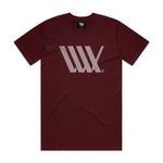 The LUXBMX Flag Tee Maroon is a heavyweight t-shirt with a light gray geometric logo on the chest, featuring overlapping lines forming an angular design.