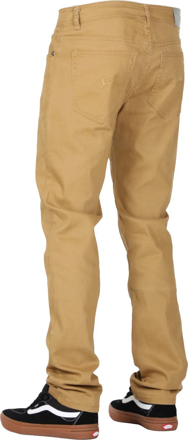 A person wearing FP Pants Relaxed Fit Chino Bone made from stretch fabric and black sneakers with white laces and brown soles is shown from the back.