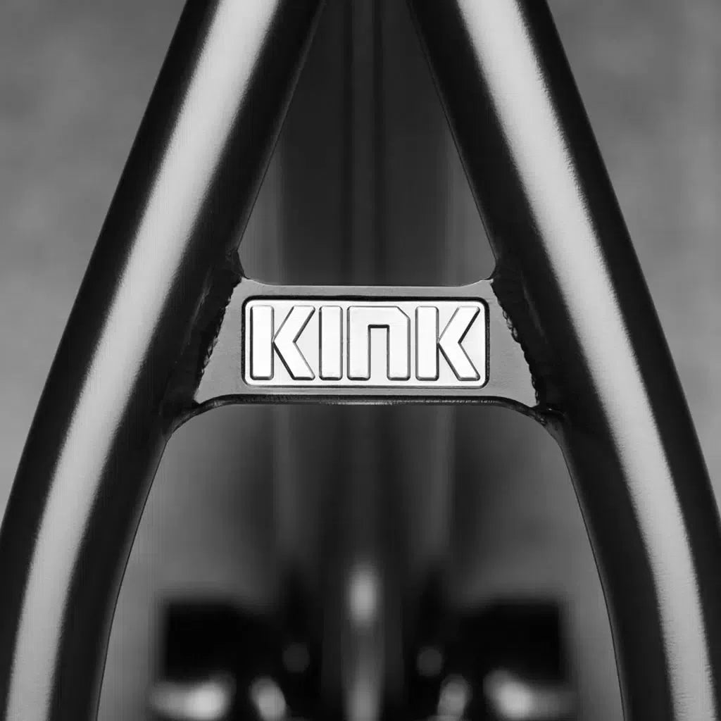 Close-up of a black metal frame engraved with "KINK" on a silver plate, highlighting the seamless Sanko 4130 Chromoly tubing of the Kink Williams (Nathan Williams Signature) Frame.