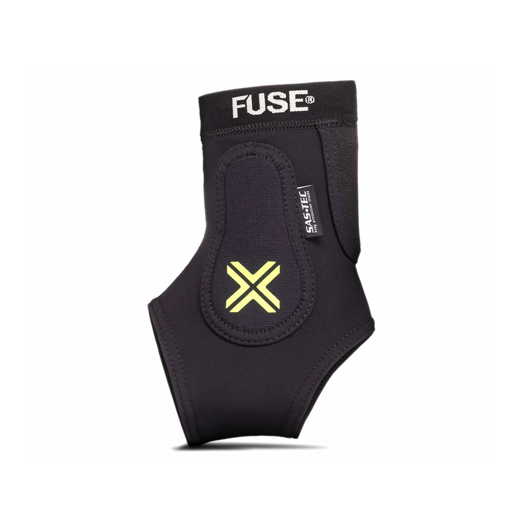 A black and yellow ankle guard with the brand name "Fuse" and "Sas-Tec" written on it. The guard, featuring EVA foam padding for added comfort, has a prominent X design in yellow on the front.