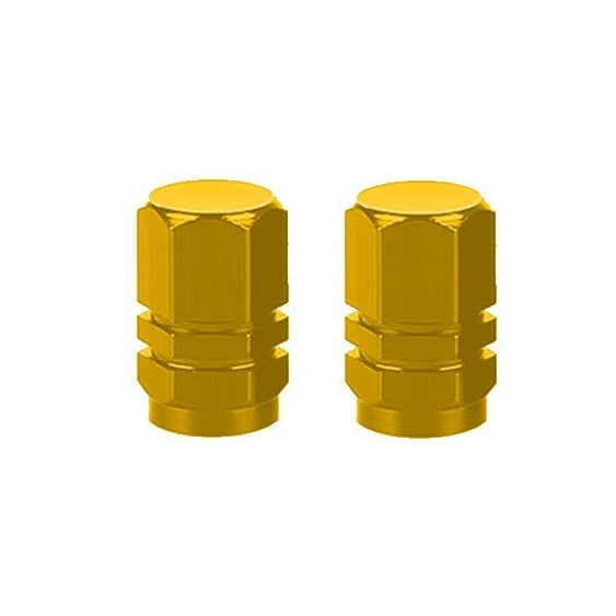 The Hexagon Valve Caps (Pair) in a gold-colored alloy lie side by side on a pristine white background, adding a pop of color to enhance your ride’s look.