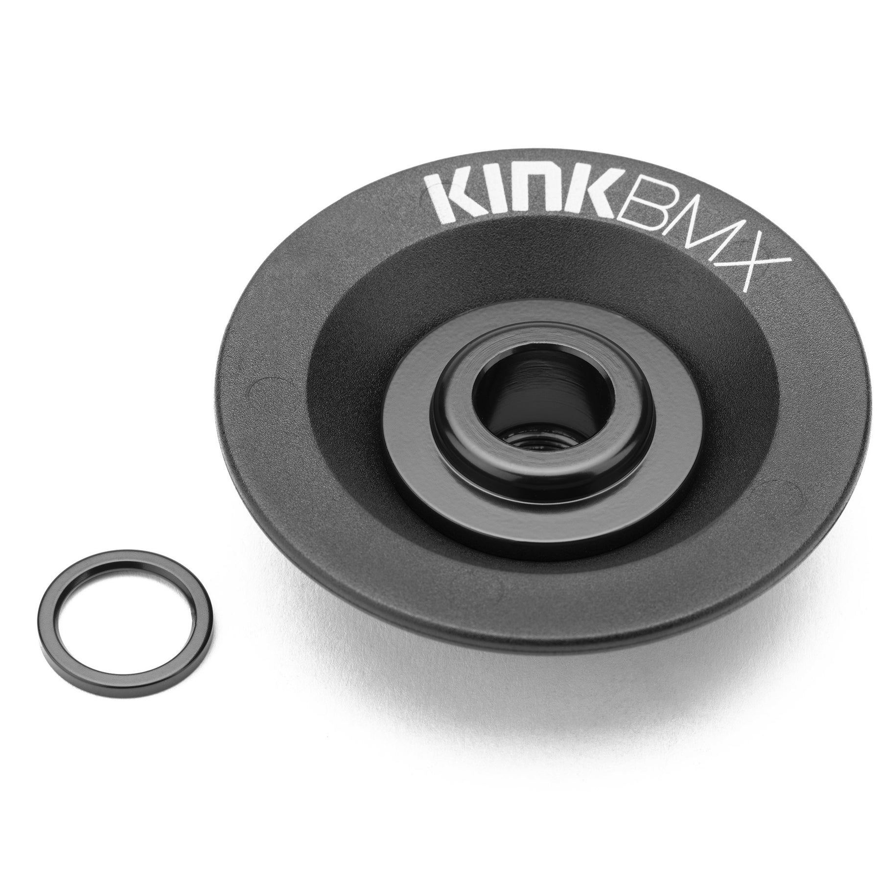 On a white background, the Kink Universal Coaster Hub Guard and a small metal ring are displayed. The black guard showcases the "KINK BMX" logo and is built with a durable chromoly core for strength during intense freecoaster sessions.