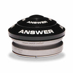 The product is a black and silver Answer 1-1/8 to 1″ Integrated Headset Reducer, designed for fitting 1-1/8 inch frames to 1-inch forks. It includes a tapered design and has the specifications engraved, featuring the "Answer" text on top.