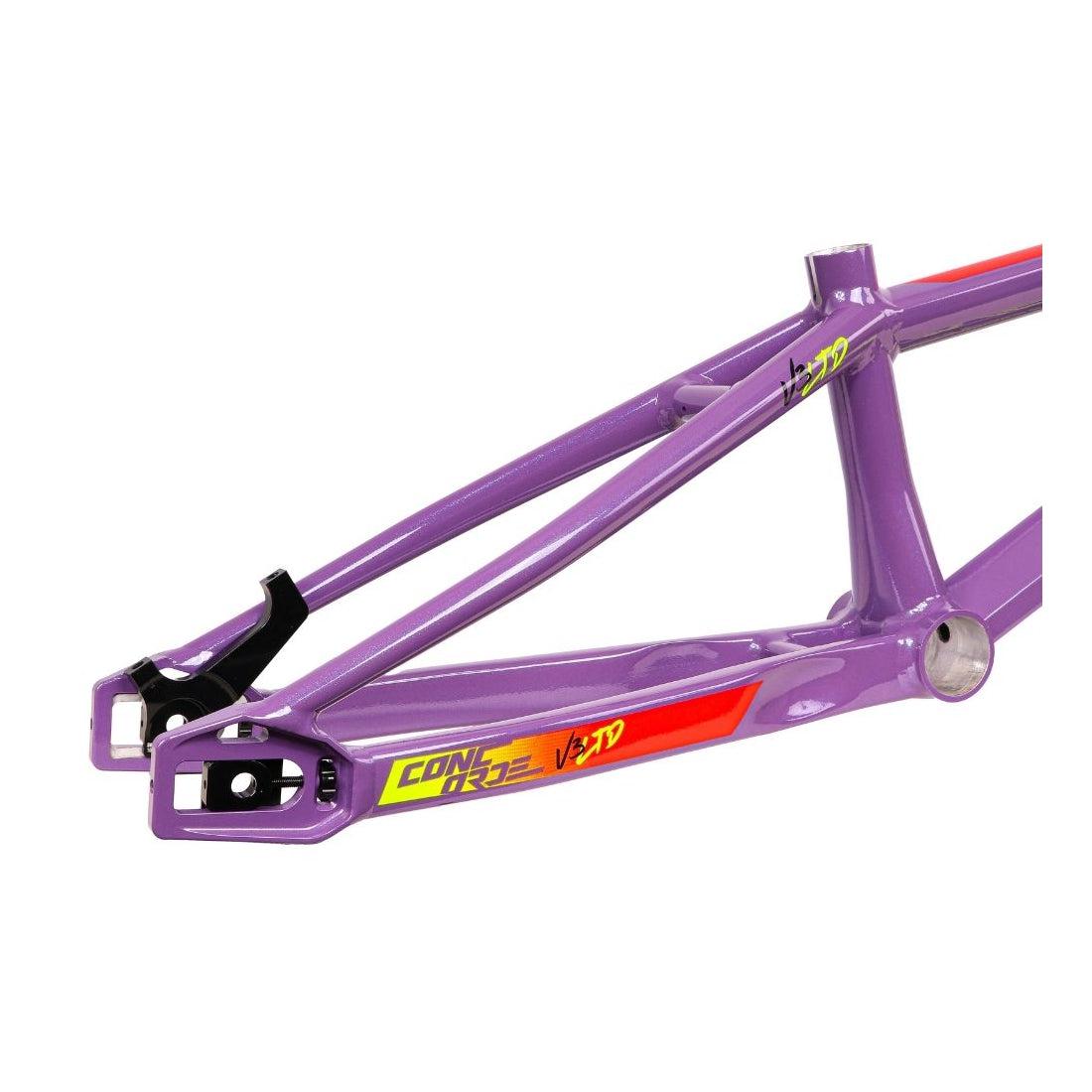 Close-up of the Inspyre Concorde V3 Pro L Frame in purple, featuring yellow and red graphics. The hydroformed aluminium construction provides a distinctive geometric design and exceptional lateral rigidity, offering both performance and style.