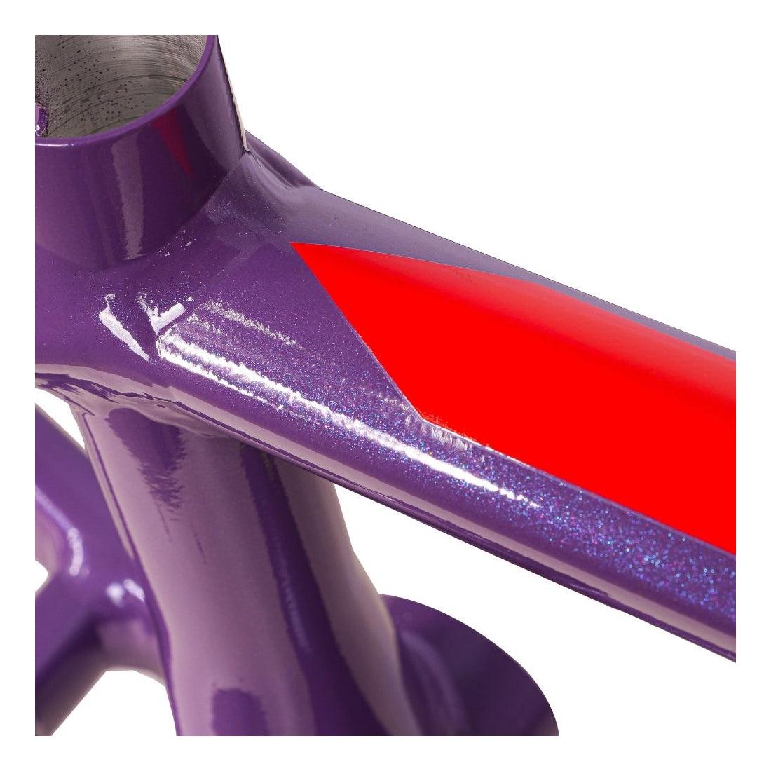 Close-up of the Inspyre Concorde V3 Pro L Frame, a purple metal structure featuring a glossy red triangle design, highlighting the lateral rigidity characteristic of hydroformed aluminium used in BMX race frames.