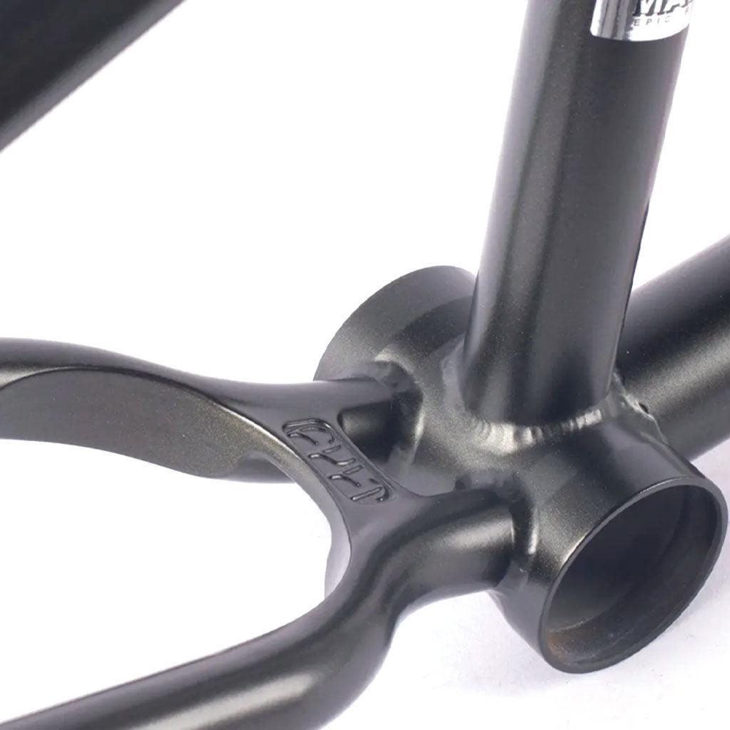 Close-up of the Cult Biggie Frame (Devon Smilie Signature) reveals its black metal structure with a welded joint near the bottom bracket shell, emphasizing its rugged street geometry.