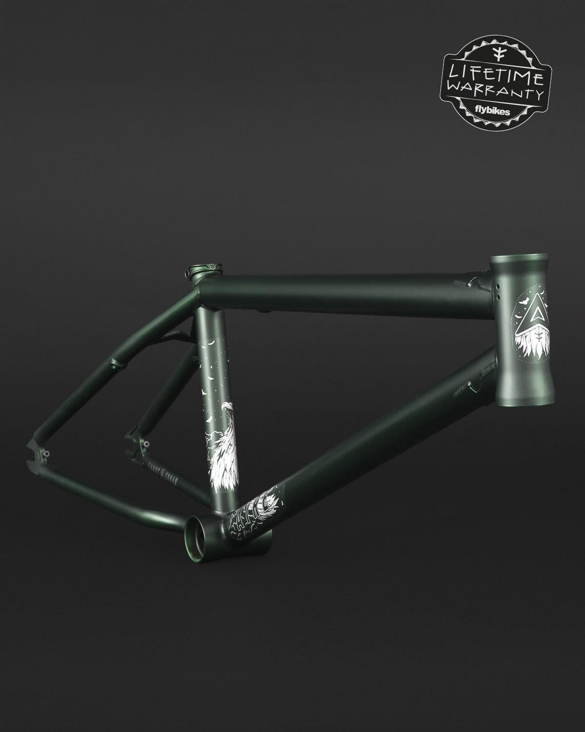 The Fly Bikes Aire Frame, made from 4130 Cr-Mo steel in matte black with graphic designs, is displayed against a dark background. The "Lifetime Warranty" logo appears prominently in the top right corner.